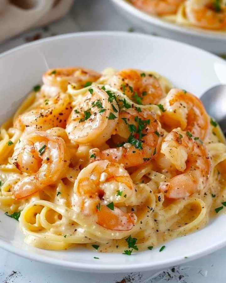 Creamy prawn pasta with a colorful salsa topping.

