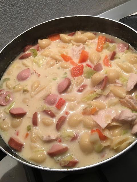 Celery cream soup with pasta in a bowl.