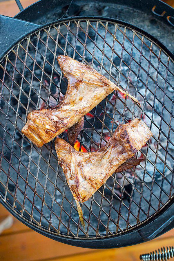 Savory fish cut with a charred, golden-brown finish.

